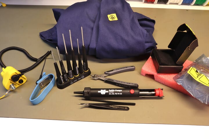 Different forms of ESD protection: ESD tools, wrist band, packaging, lab coat and table mat